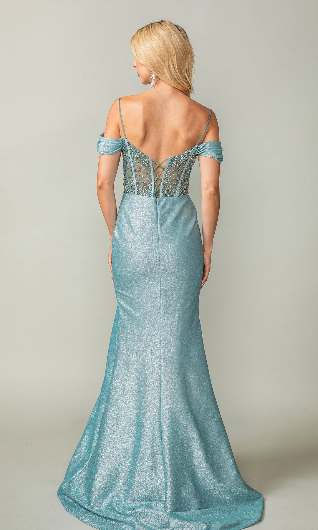 Woman wearing the Beaded-Corset Long Prom Dress: Dancing Queen 4367 in shimmering light blue, featuring a fitted bodice, lace-up back detail, and flared skirt, shown from the back against a plain background.